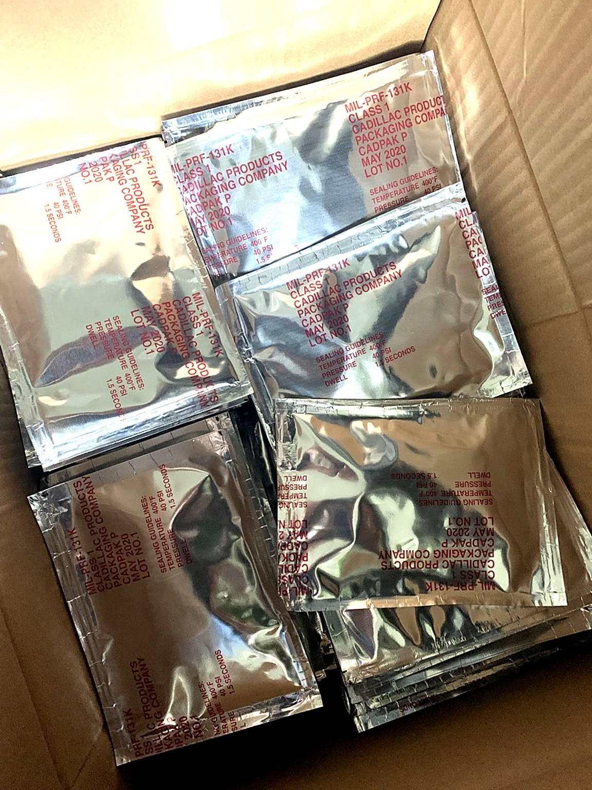 A carton of sealed foil moisture barrier bags, each holding one desiccant pack
